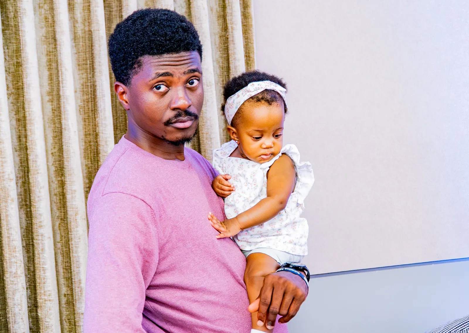 A man holding a young child at a church gathering